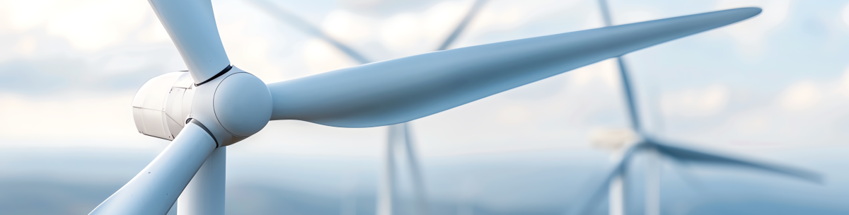 Close-up of a white wind turbine with large blades, set against a blurred background of additional turbines and a cloudy sky. The image emphasizes renewable energy and clean technology. by Standex Detect