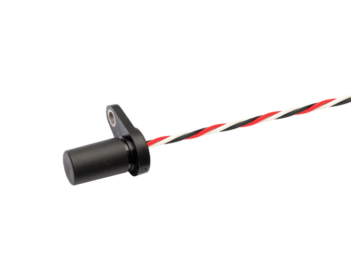 A black cylindrical VPA Series Analog Ferrous Metal Proximity Sensor with a mounting flange, attached to a twisted pair of red, white, and black wires on a white background. by Standex Detect