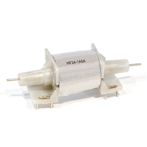 A cylindrical electronic component from the HF Series, this Reed Relay features a white body labeled HF24-1A54, mounted on a white plastic base with metal pins and axles protruding from both ends. by Standex Detect