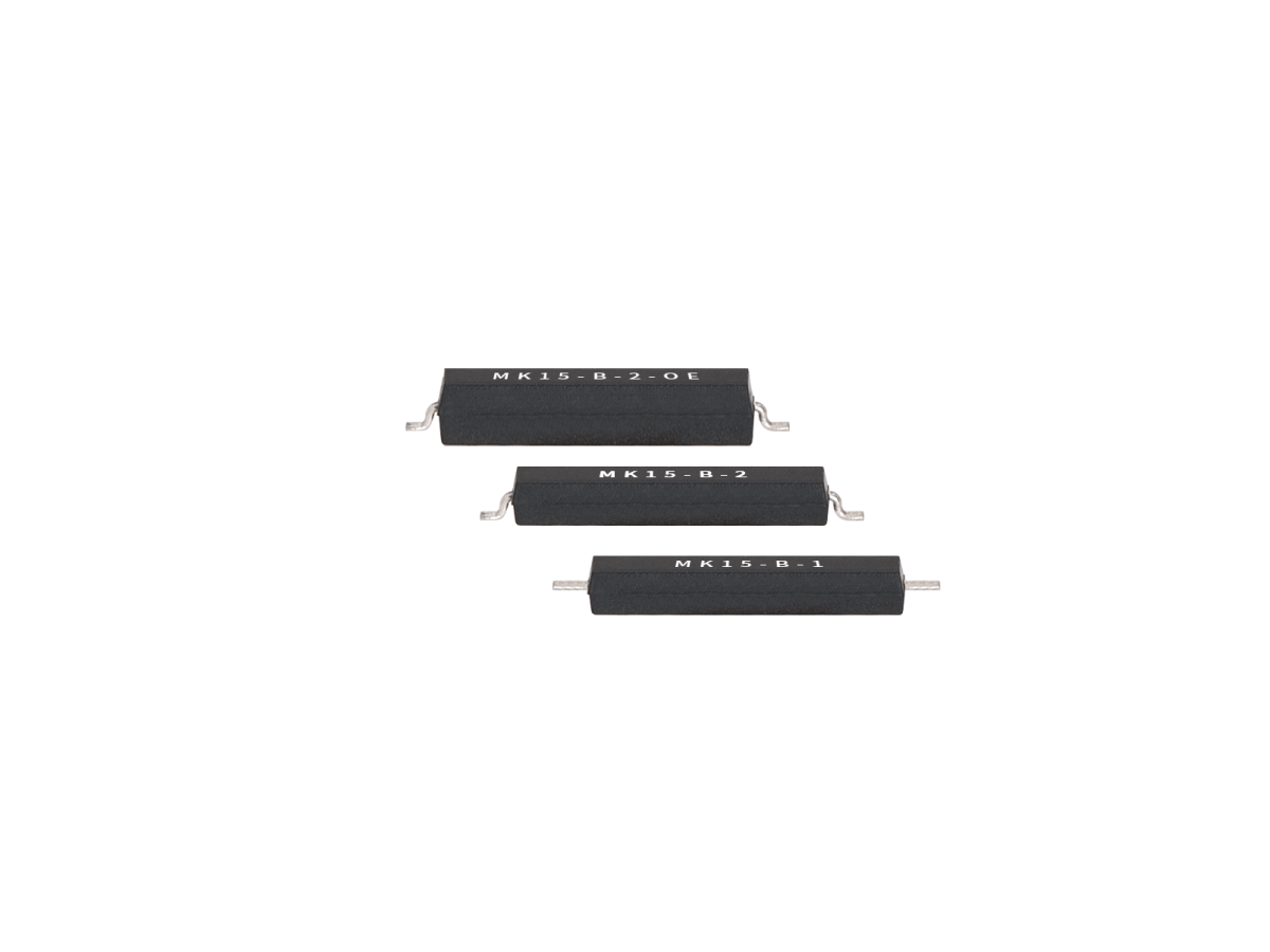 Three black rectangular MK15 Series Surface Mount Reed Switch components, labeled MK15-B-2.0E, MK15-B-2, and MK15-B-1, are arranged in a staggered line on a white background with silver terminals. by Standex Detect