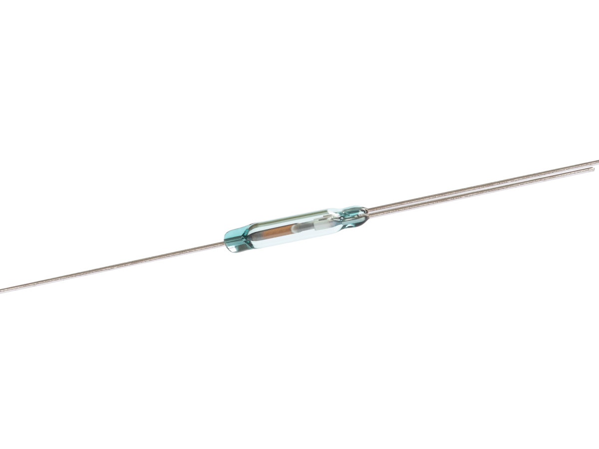 A small ORT551 Reed Switch with metal leads extending from both ends is displayed on a white background. The cylindrical glass body of this reed switch encloses thin metal contacts inside. by Standex Detect